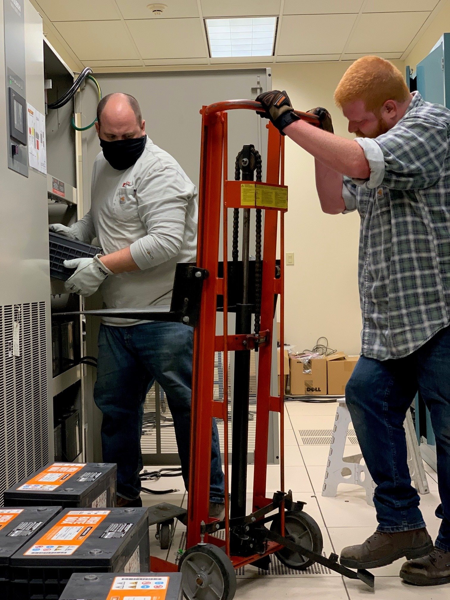 Technicians replacing UPS batteries